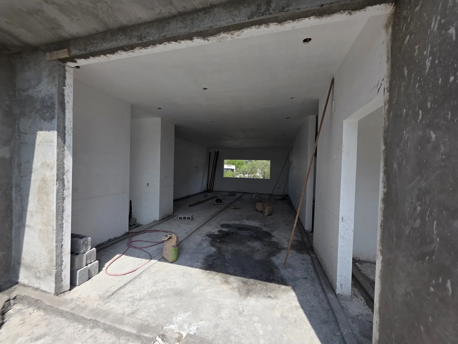 Cochera o estancia amplia con vano hacia exterior y muros terminados — Casa Las Esmeraldas Tempus Monterrey